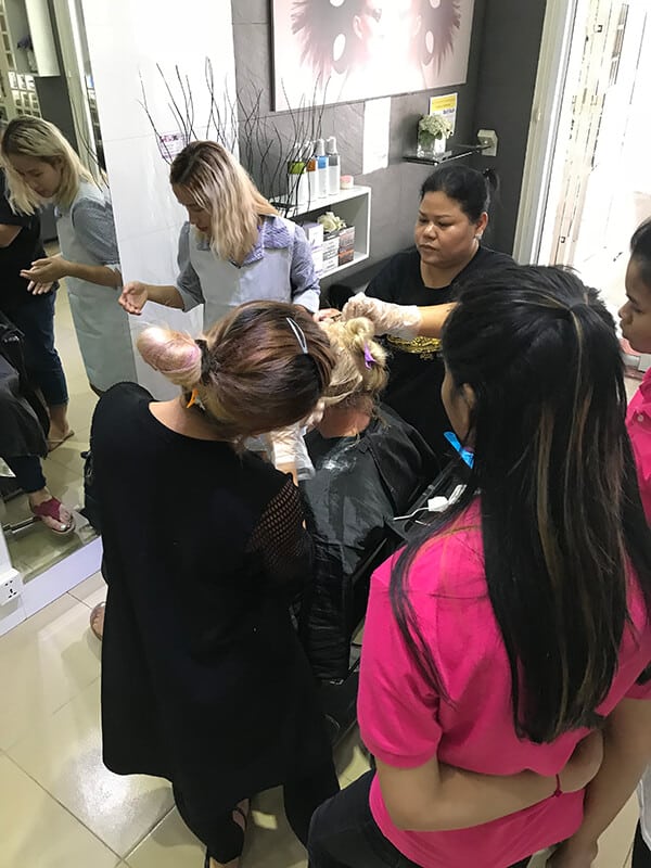 Women learning hair dressing techniques at Beautiful You Training Ministries
